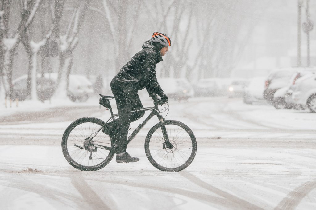 A cyclist on a snowy road.